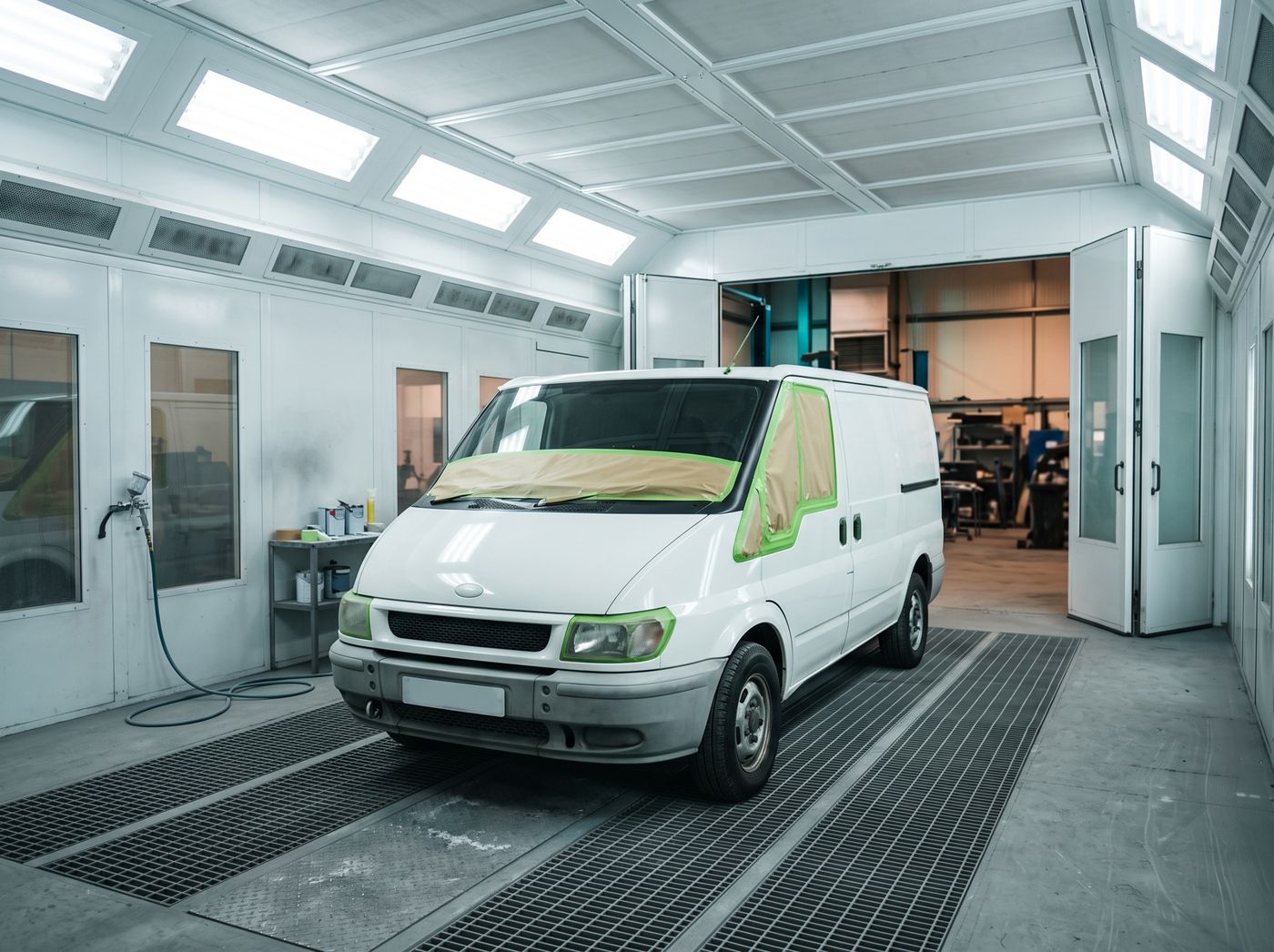 Illustrative photo of a van inside a large spray paint booth